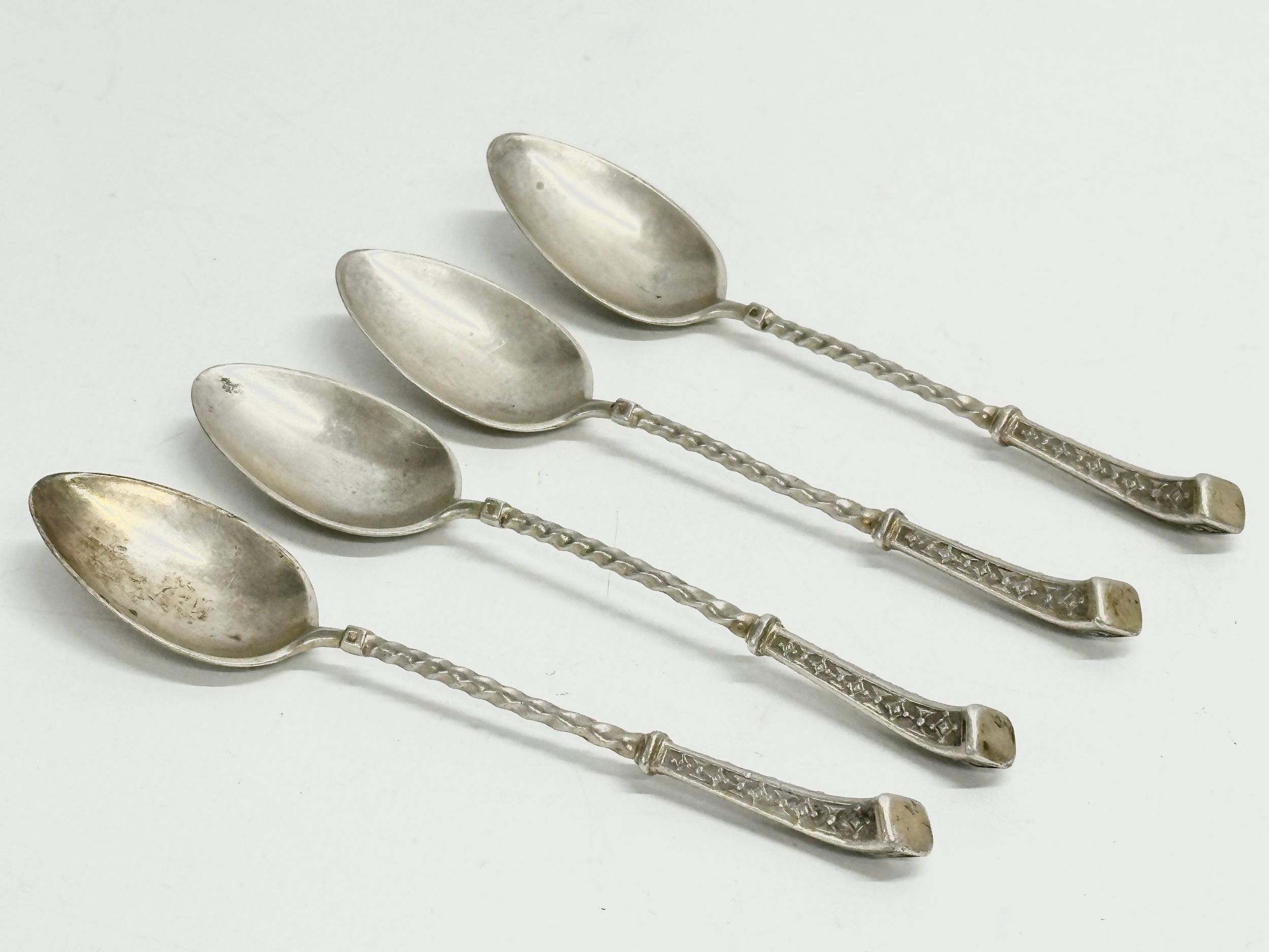 A set of 4 silver spoons stamped 800. 57.15 grams.