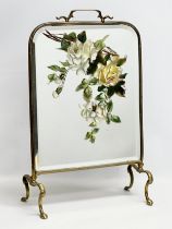 An Edwardian brass framed firescreen with painted mirror. 38x20x59cm