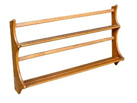 An Ercol Mid Century Elm wall hanging plate rack. 96.5cm