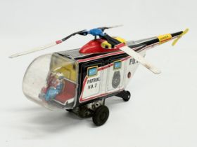 A vintage tin plate police patrol helicopter. 26cm