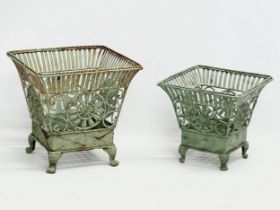 A pair of wrought iron garden planters. Largest 32x32x31cm