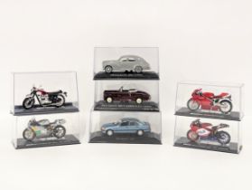 A collection of model cars and motorbikes