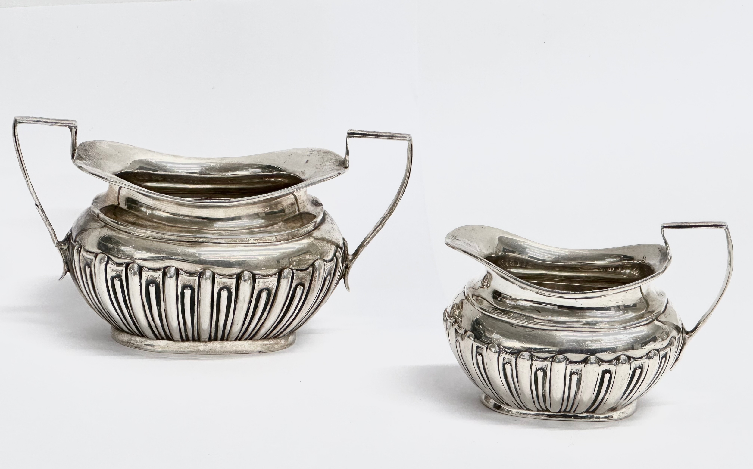 A late 19th century silver sucrier and matching cream jug by James and William Deakin. Circa 1894-