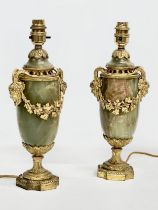 A pair of excellent quality early 20th century gilt brass and onyx table lamps with rams head masks,