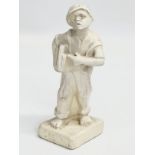 An early 20th century ‘Speshul’ plaster newspaper boy figure. 19cm