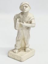 An early 20th century ‘Speshul’ plaster newspaper boy figure. 19cm