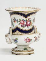 A mid 18th century Sèvres hand painted porcelain pedestal vase with masked devil heads and