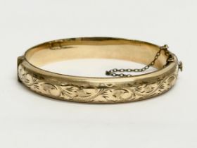 A vintage rolled gold bangle with case.