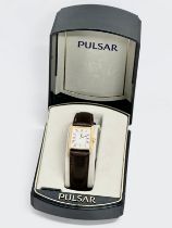 A Pulsar watch with case.