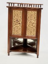 A late Victorian mahogany wall hanging corner cabinet with gilt painted aesthetic movement panels