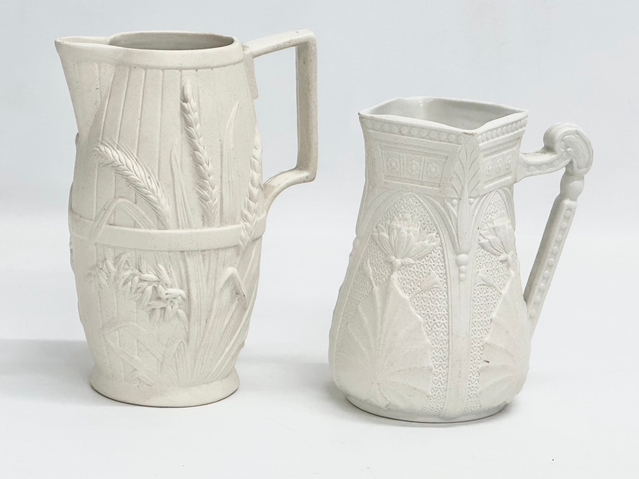 2 mid 19th century Copeland Parian Ware jugs. A Harvest Barrel jug 13x18cm.