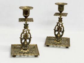 A pair of Victorian pierced brass candlesticks with lion mask design and butterfly motif. 12x12x21cm