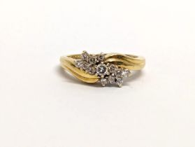 An 18ct gold diamond cluster ring. 4.63 grams. Size L.