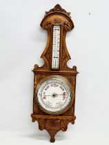 A Victorian carved oak barometer. 28x84cm
