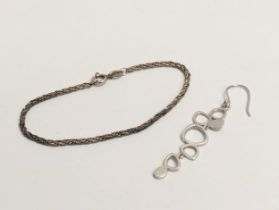 A silver bracelet and silver earring. 5.52g