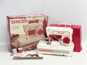 A Singer 'Lockstitch' sewing machine for children in original box.