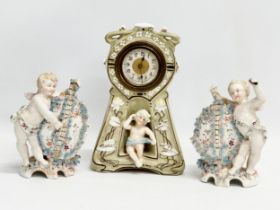 Late 19th century porcelain cherubs. A pair of late 19th century cherub spill vases and a