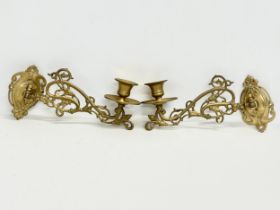 A pair of early 20th century ornate brass wall bracket candleholders. 22cm