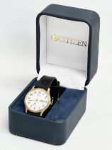 A Citizen watch with case.