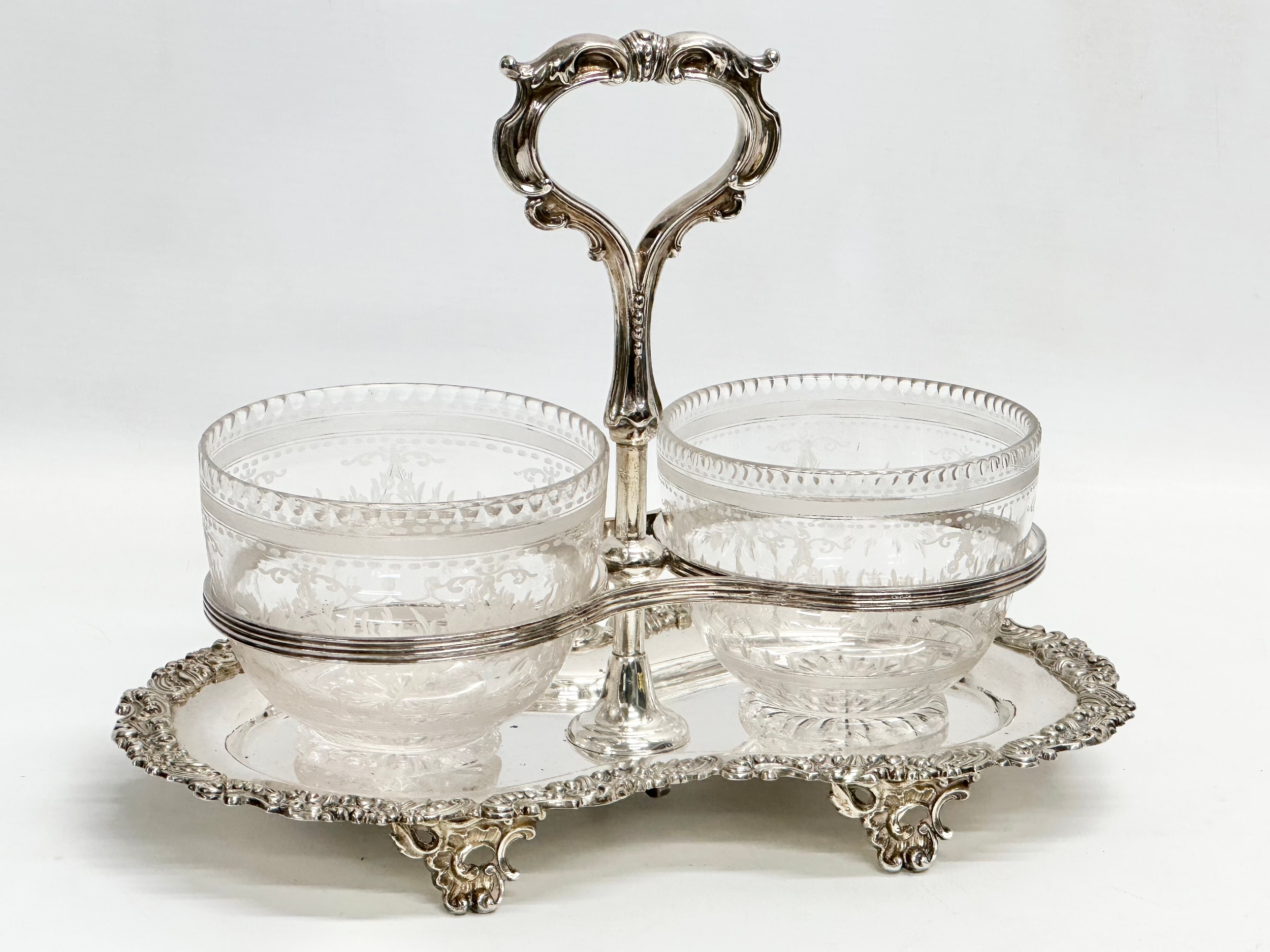 A Victorian silver plated sugar and cream stand/tea caddy, with etched glass bowls. Bowls measure