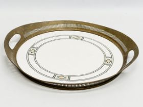 An Art Nouveau ceramic tray with pierced brass frame by WMF Wächtersbach, Germany. Circa 1910.