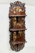 A large late 19th century Japanese late Meiji period carved wall shelf with painted flower motif,