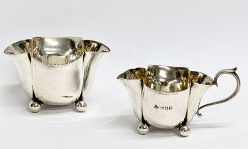 A Horace Woodward & Co Ltd silver sugar bowl and matching cream jug. Circa 1893-1919. London. 133.78