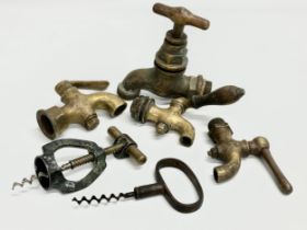 A vintage Zodiac Rollover Corkscrew and 4 early 20th century brass taps