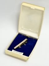 A gold on silver diamond cut brooch with case.