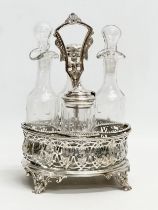 A Victorian pierced silver plated cruet set with 4 pressed glass bottles. Circa 1860-1880.