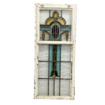 A large vintage stained glass panel in metal window frame. 53.5x124cm