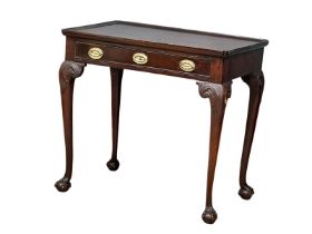 A mid 19th century Irish Chippendale Revival mahogany silver table with drawer on Ball & Claw