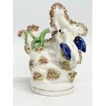 A rare mid 19th century Staffordshire pottery birds nest and snake figure. 12x14.5cm