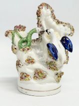A rare mid 19th century Staffordshire pottery birds nest and snake figure. 12x14.5cm
