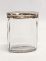 A 19th century silver lidded vanity jar by Moritz Wolfsky. London, 1883. Lid weighs 17.8g. 7x8.5cm