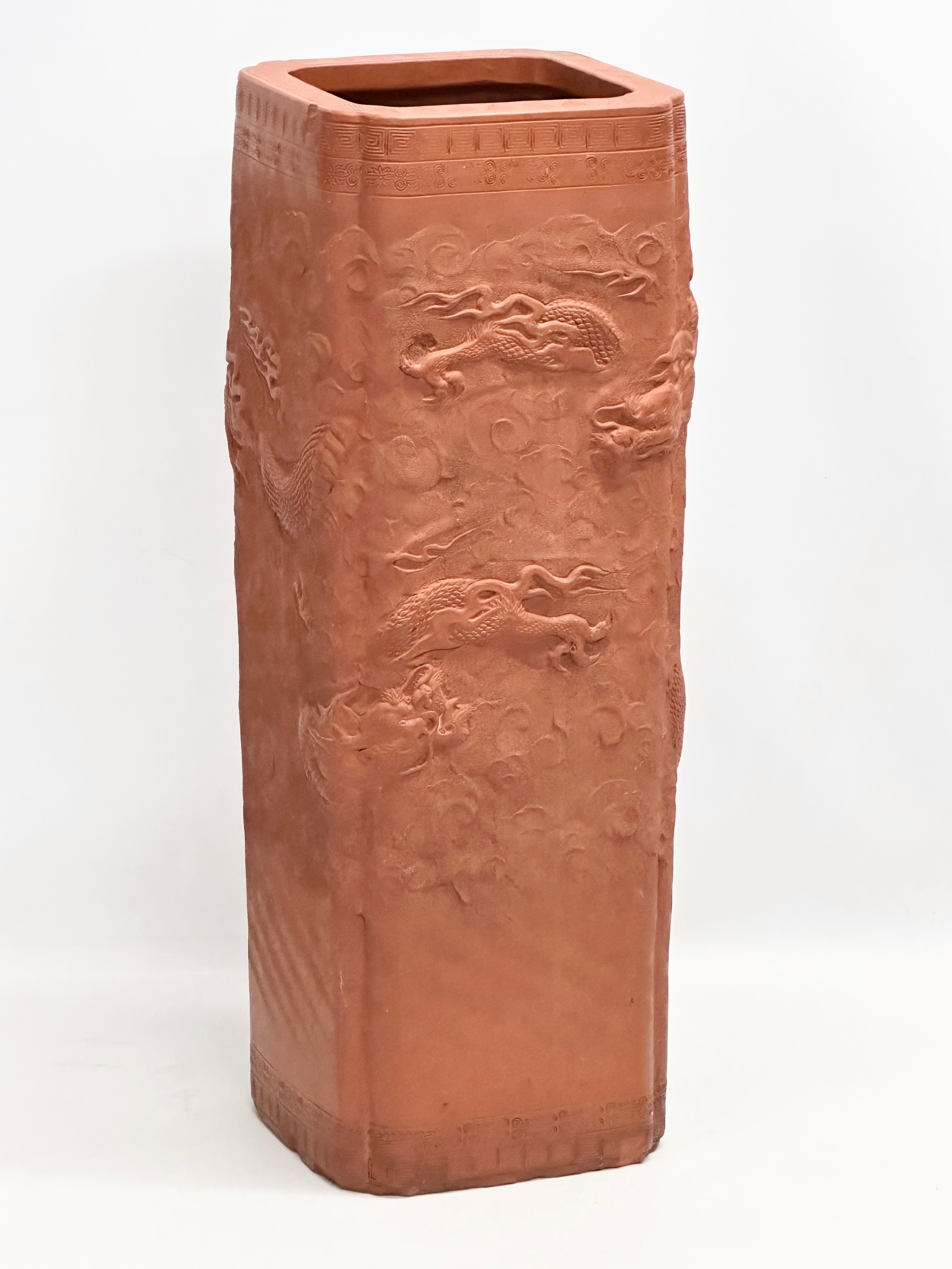 A Chinese terracotta stick stand/planter with dragon motif and Greek Key decoration. 21x21x61cm - Image 3 of 8