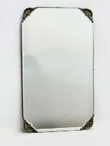 An early 20th century bevelled mirror. 69x41cm