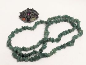A large jade necklace with a vintage Irish Celtic brooch stamped Miracle.