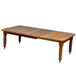 A large late Victorian Walnut 2 leaf wind out dining table. Circa 1880-1890. Fully extended