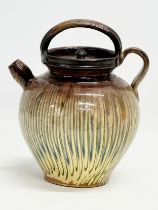 A vintage French drip glazed stoneware wine decanter attributed to Jean Marais. 20x16x24cm