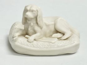 A 4th period Belleek pottery ‘Spaniel on Pillow’ figurine. 12x10x8cm