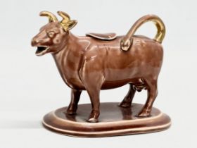 A late 19th century/early 20th century brown pottery Cow Creamer. 16x9x12cm