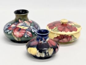 3 pieces of Moorcroft pottery. A Moorcroft ‘Orchid’ vase 13x10cm. A Moorcroft ‘Wisteria’ vase