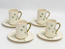 An 8 piece Belleek ‘Shamrock’ coffee service. 1 green stamp mug and 7 brown stamps. Saucers