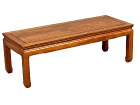 A Chinese teak coffee table. 122x48x41cm