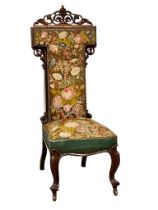 A large Victorian rosewood Prie Dieu chair with original tapestry seat and back on carved cabriole