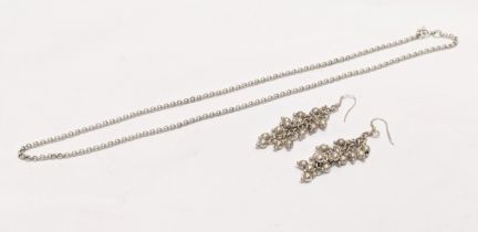 A silver chain with a pair of silver earrings. 15.8g