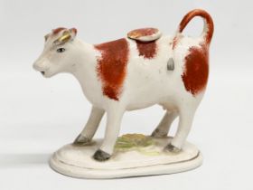 A late 19th century Victorian Staffordshire pottery Cow Creamer. 16x13cm