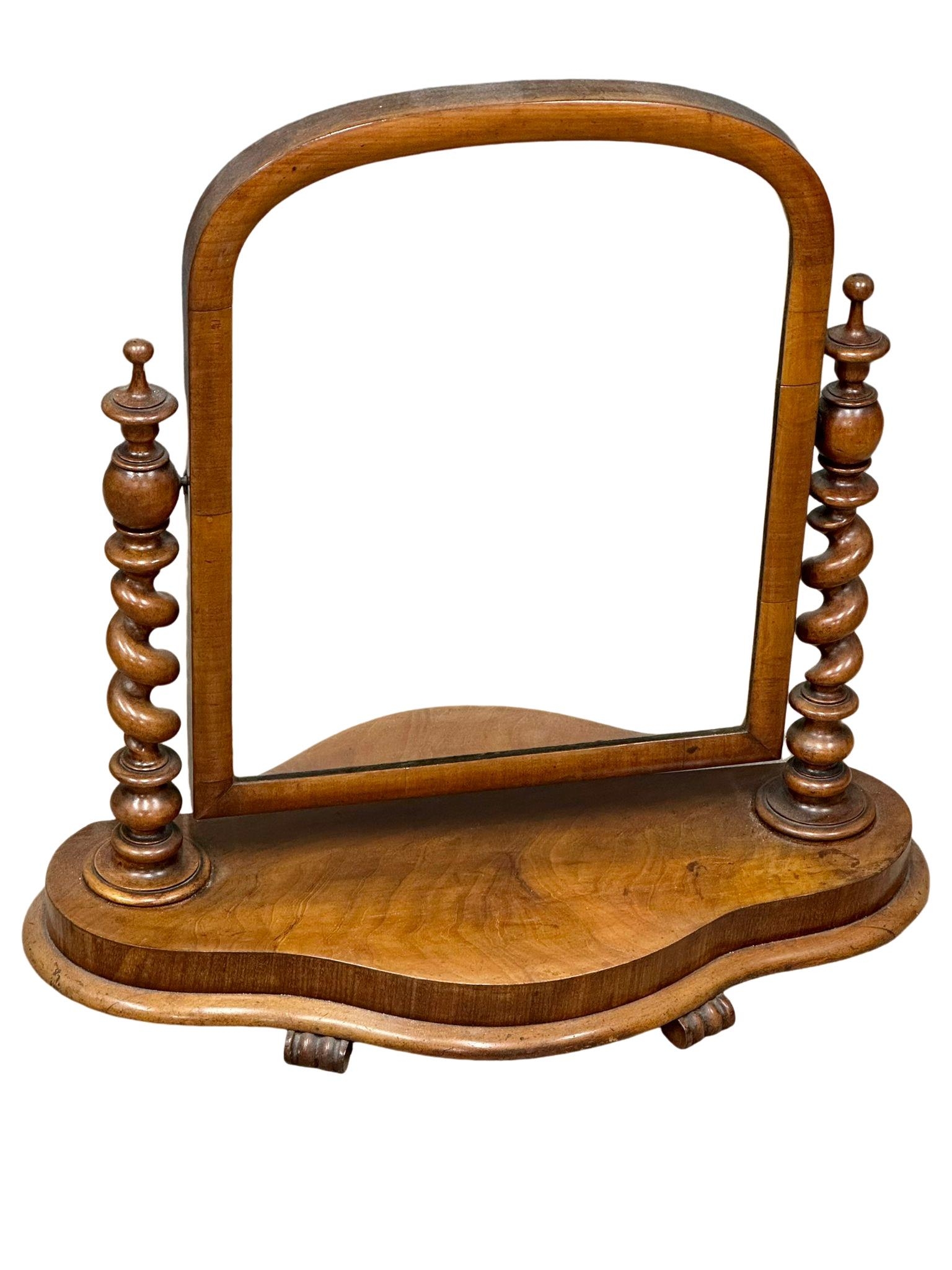A Victorian mahogany dressing mirror with Barley Twist pillars. 70x70cm(2)