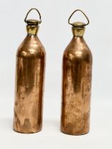 A pair of late 19th/early 20th century copper hot water bottles. 30cm